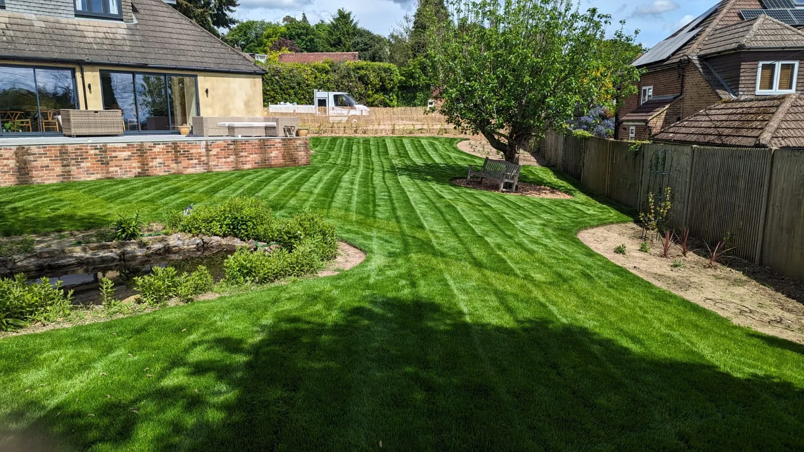 a view of a backyard with a lawn and a fence